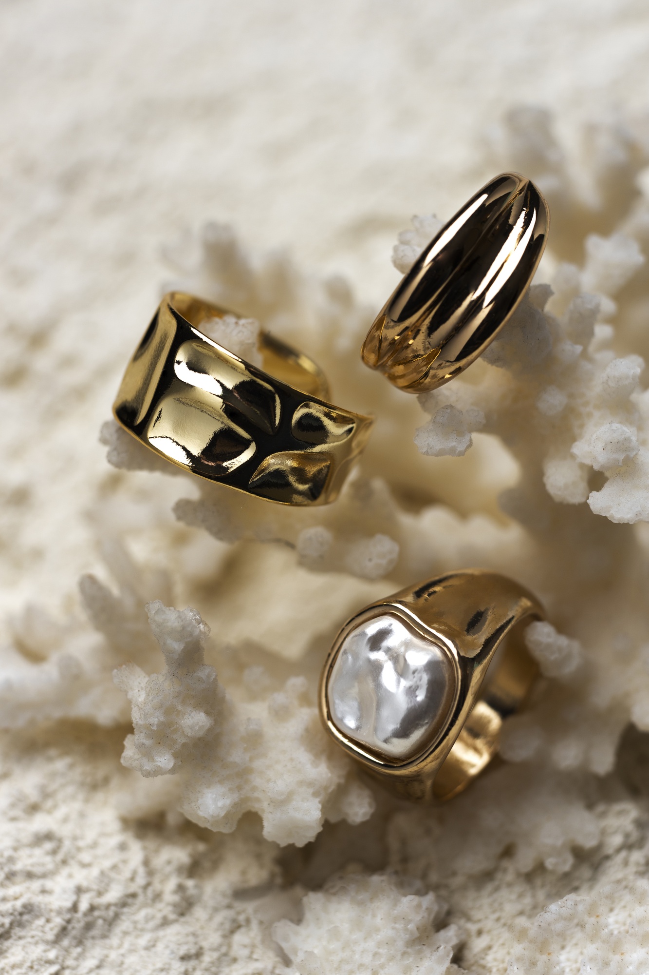 expensive golden ring displayed white coral background